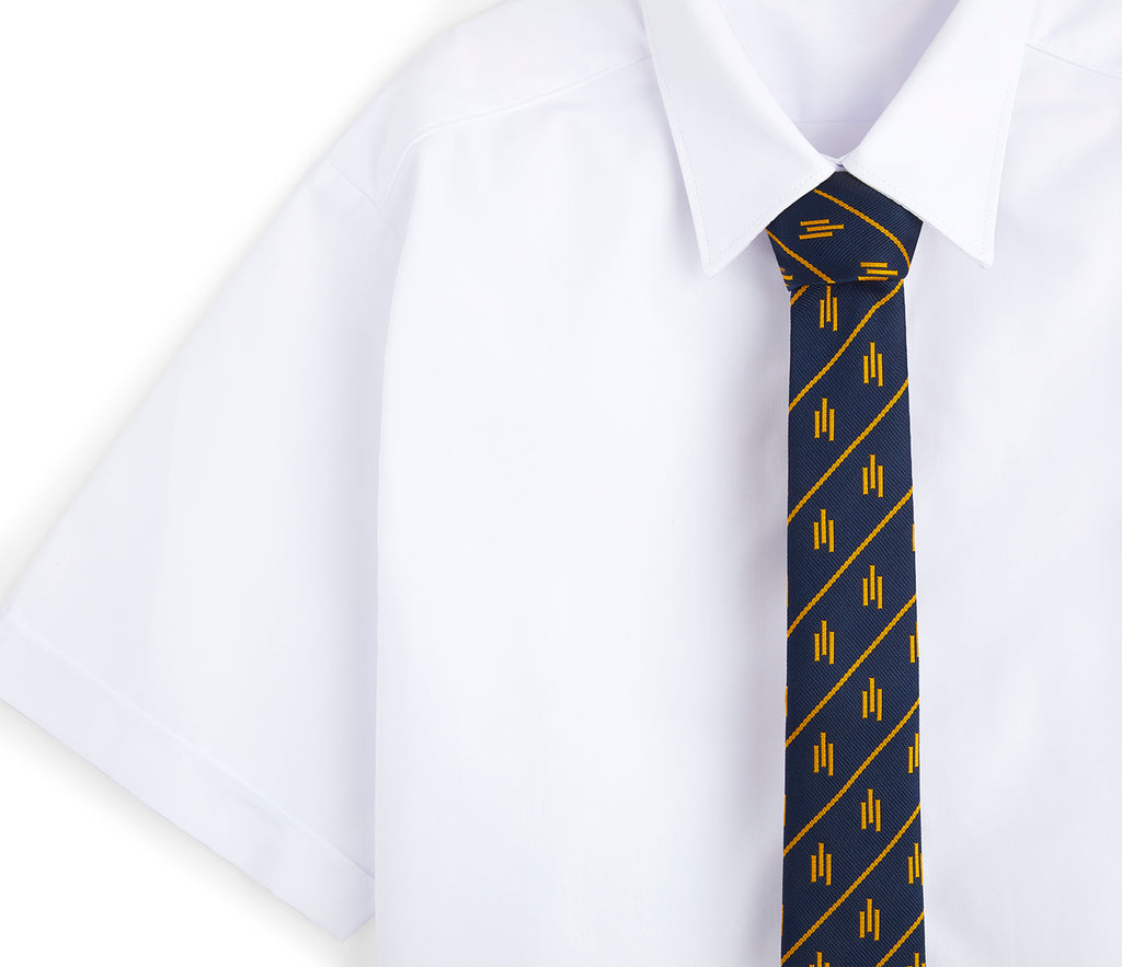 St Matthew's School, Westminster Standard Tie (Years 3-6) on a white dress shirt, featuring a neatly positioned blue necktie with a classic collar.