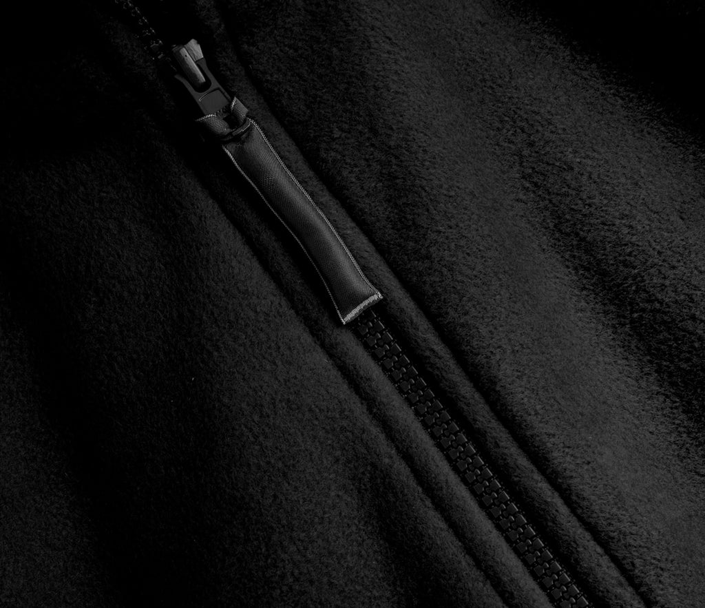 Zeco Polar Fleece - Black, showcasing a close-up of the fleece fabric with a durable YKK zipper and fabric-wrapped pull tab, emphasizing quality and functionality.