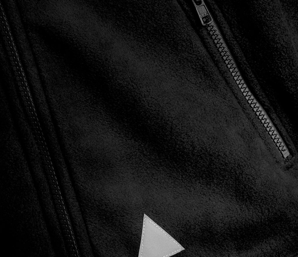 Zeco Polar Fleece - Black, showcasing close-up of dual YKK zippers, triangular patch, emphasizing heavyweight anti-pill fleece and elasticated cuffs with full zip fastening.