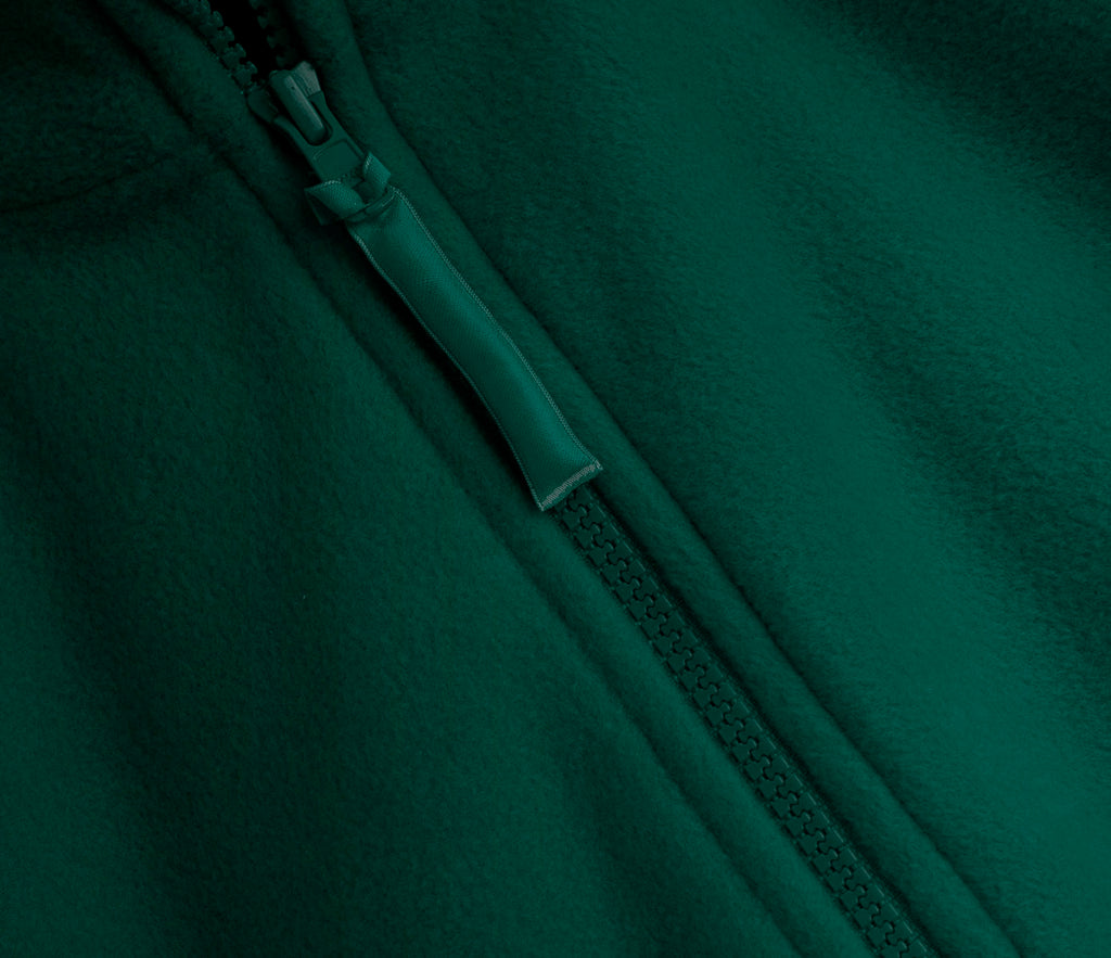 Close-up of Zeco Polar Fleece - Bottle Green showing central YKK zip, soft textured heavyweight fabric, and elasticated cuffs for comfort.